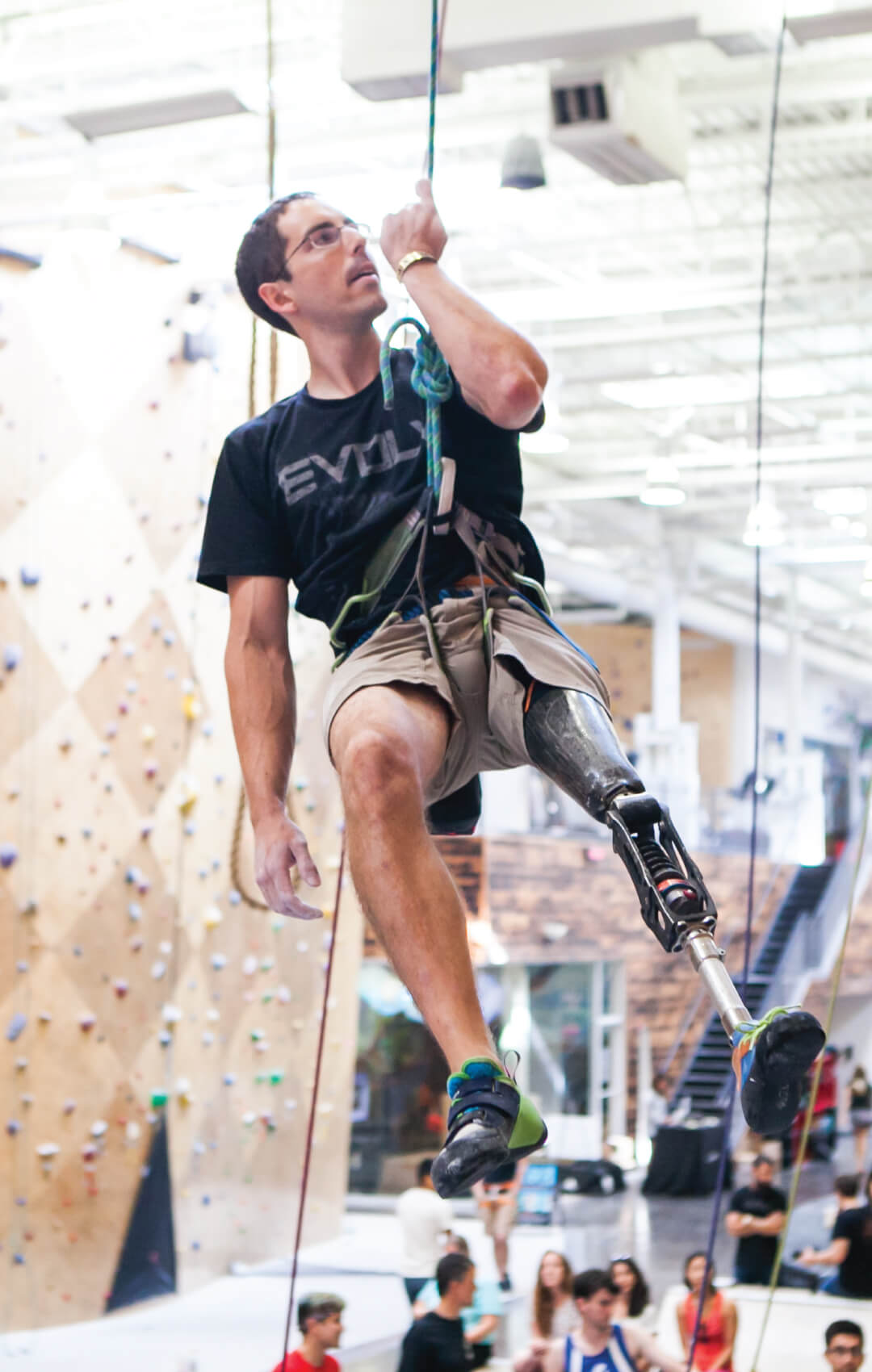 Man with prosthetic leg indoor rock climbing