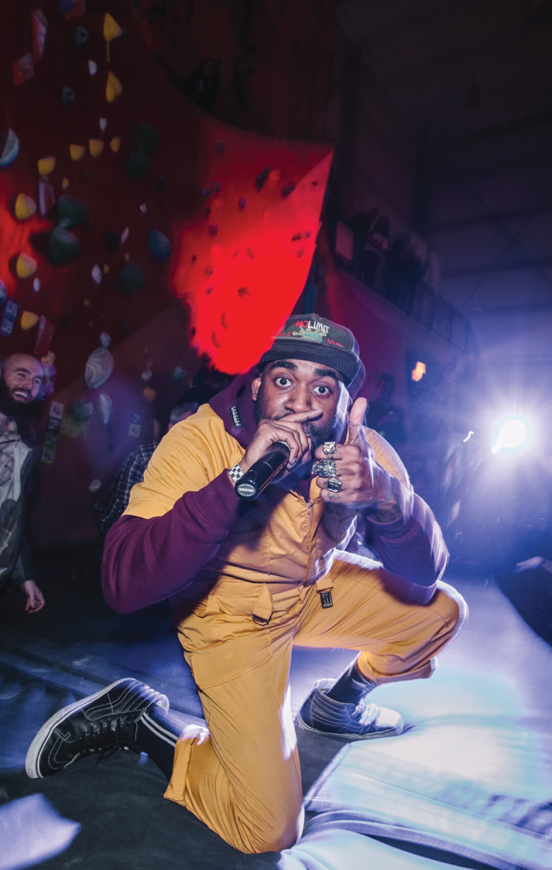 Man performing at indoor rock climbing event