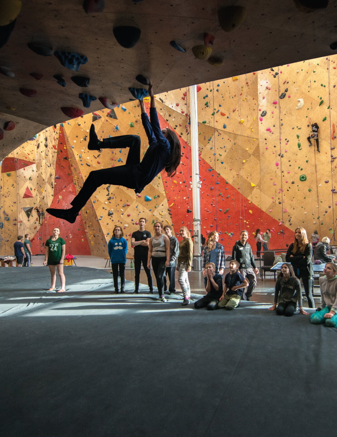 Group of students watching their instructor rock climb